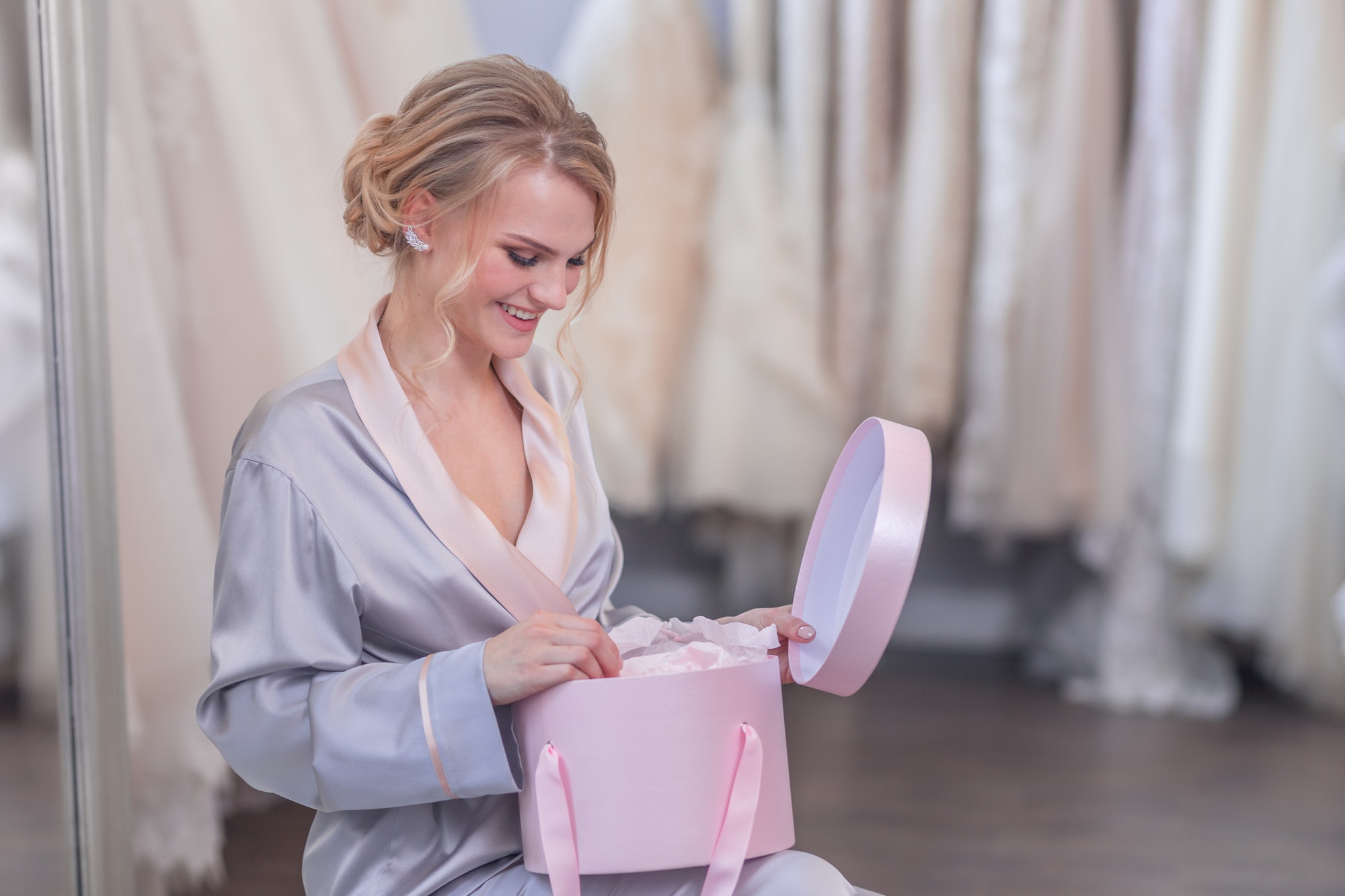 Smiling young girl with a gift box