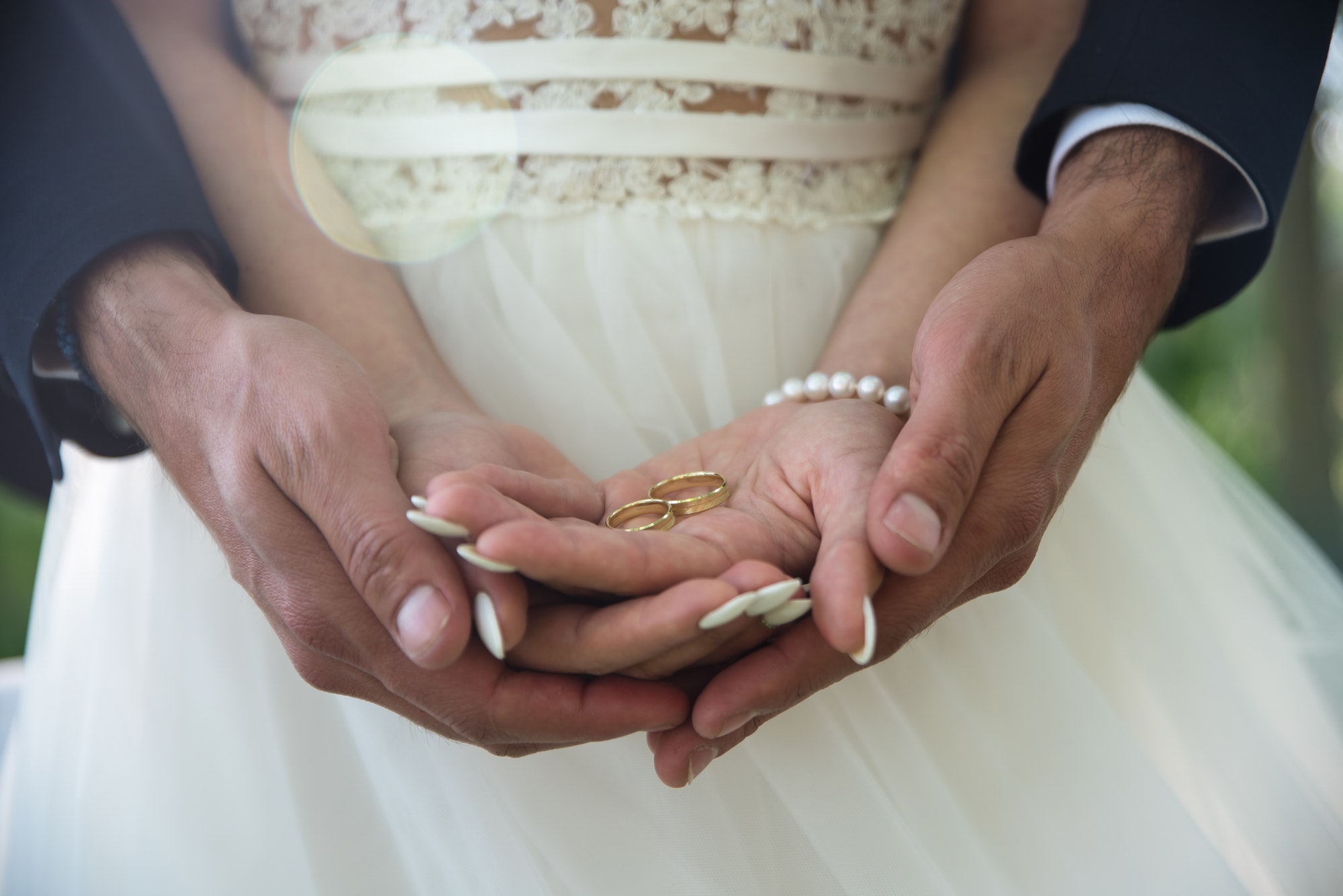 Two golden wedding rings on bride and groom's palms. Wedding rin