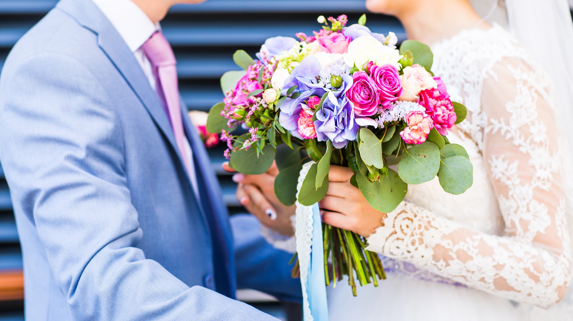 Wedding flowers ,Woman holding colorful bouquet with her hands on wedding day