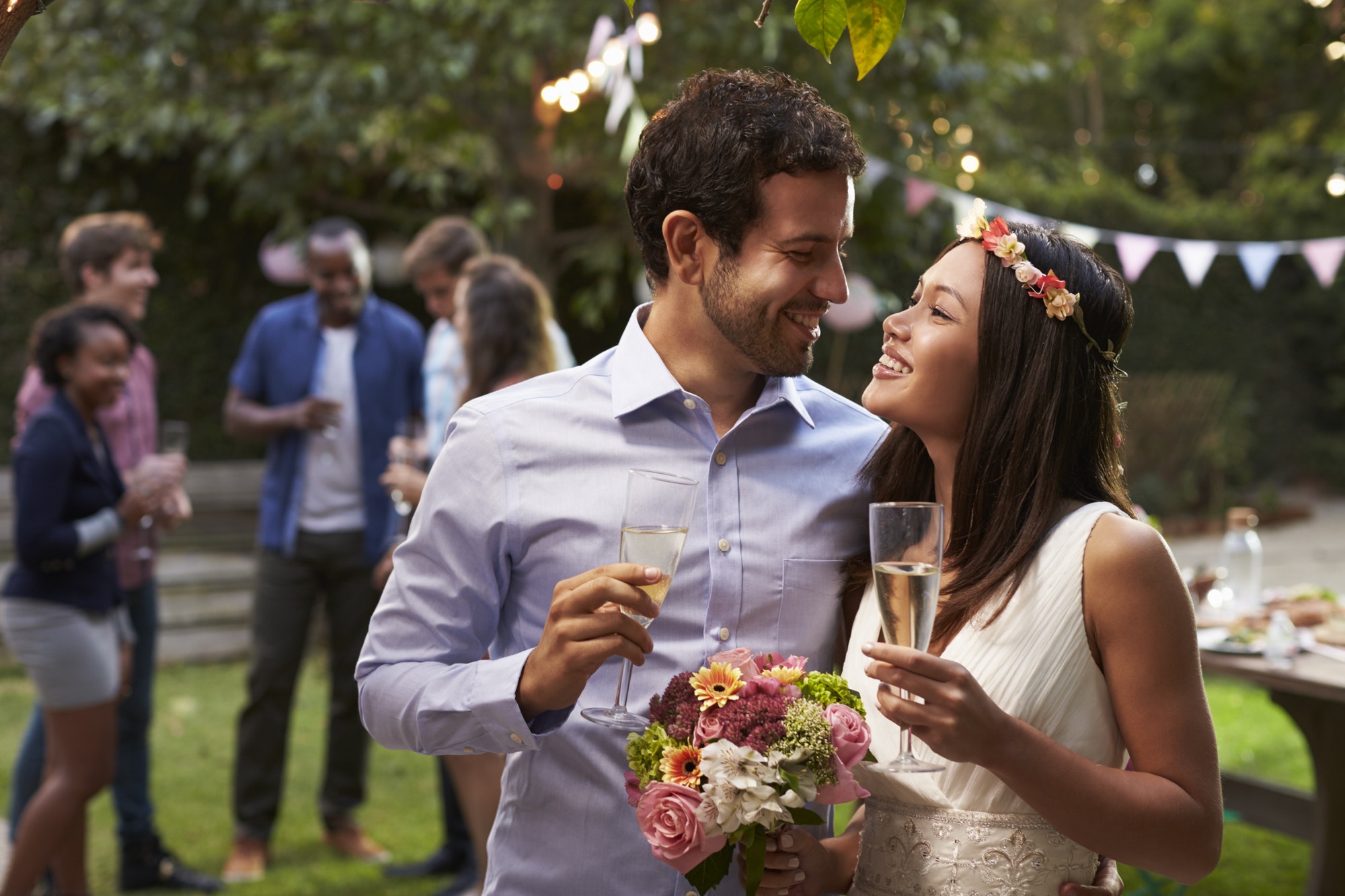 Young Couple Celebrating Wedding With Party In Backyard