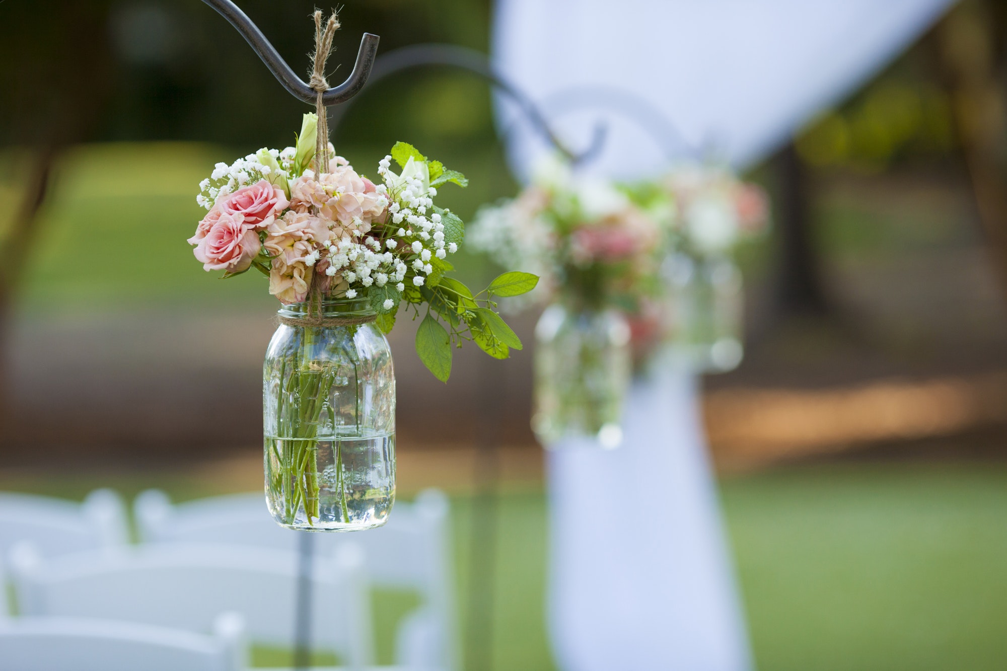 Flowers and mason jar at wedding